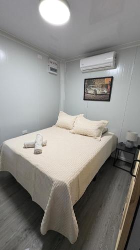 a bedroom with a large bed with a white bedspread at Leha's Apartaments in Buenos Aires