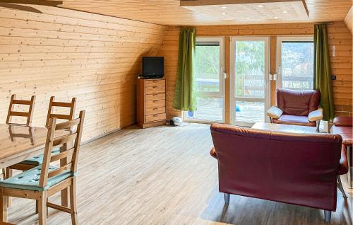 a living room with a table and two chairs at 2 Bedroom Nice Home In Bad Lobenstein in Bad Lobenstein