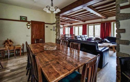 a living room with a large wooden table and chairs at Le Petit Verger in Waimes