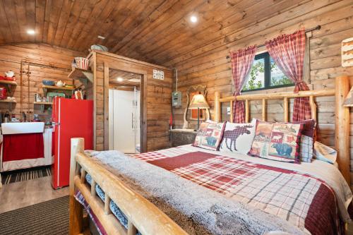 a bedroom with a bed in a log cabin at River Retreat Kananaskis in Turner Valley