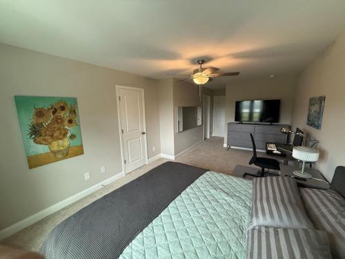 a bedroom with a bed and a desk and a television at Tide's Turn Retreat in Cedar Point