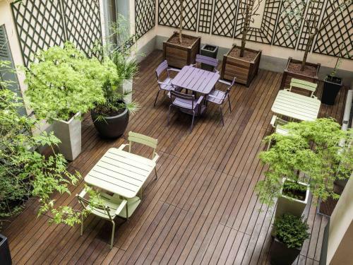 a balcony with a table and chairs and plants at Aparthotel Adagio Access Paris Philippe Auguste in Paris