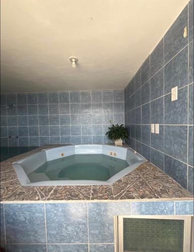 a bath tub in a bathroom with blue tiles at Alojamiento Mujer Dormida in Ambuquí