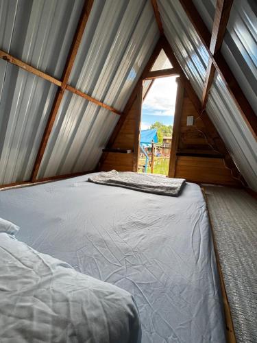 a room with a bed in a tent with a window at Camping El Paraiso in Calima