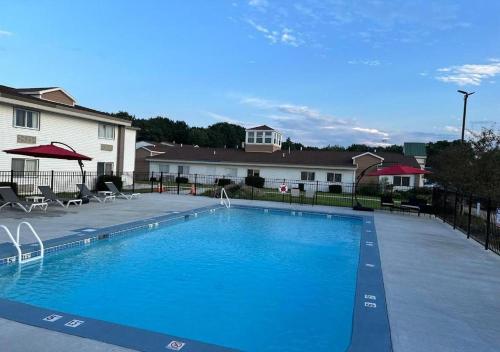 a large blue swimming pool in front of a house at Inn at Portland in Portland