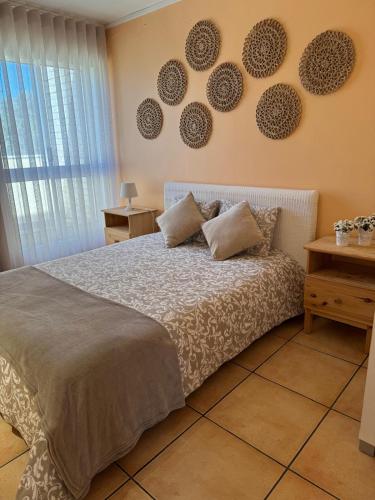 a bedroom with a bed and some plates on the wall at Ofir Guest House in Fão