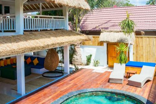 a resort with a swimming pool and a house at Villa Asmara Gili Air in Gili Islands