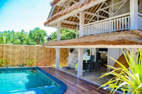 a villa with a swimming pool and a house at Villa Asmara Gili Air in Gili Islands
