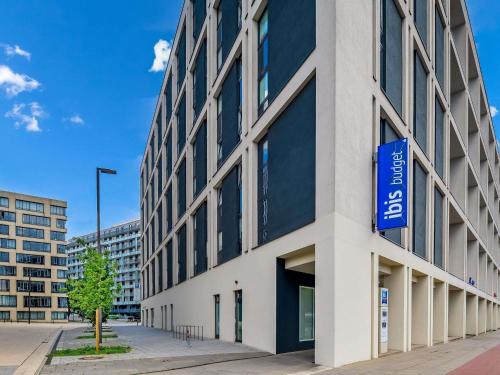 a building with a blue sign on the side of it at ibis budget Hamburg City in Hamburg