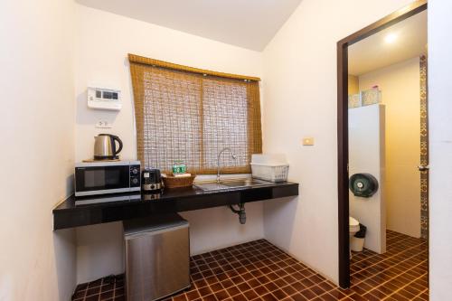 a kitchen with a counter top and a microwave at Siray Green Resort in Phuket