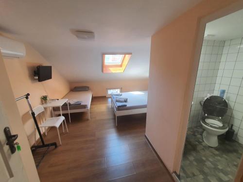a room with a bathroom with a toilet and a sink at XAH - HAN Plovdiv Center in Plovdiv