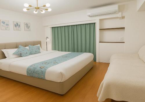 a bedroom with a large bed and a window at LIO HOTEL Tokyo Nippori in Tokyo