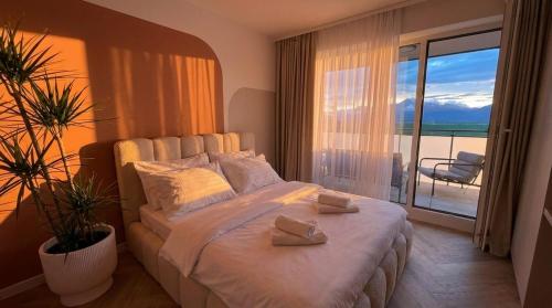 a bedroom with a bed with a view of the ocean at Bela Bonita in Spišská Belá