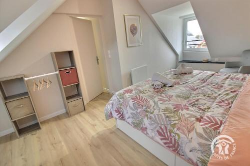 a small bedroom with a bed and a staircase at Kerlic in Ploubazlanec