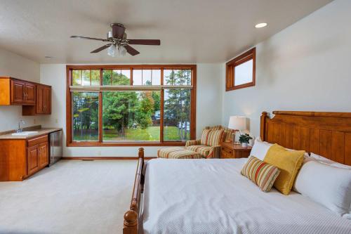 a bedroom with a bed and a large window at Bluff Haven by Simple Life Rentals in Fish Creek