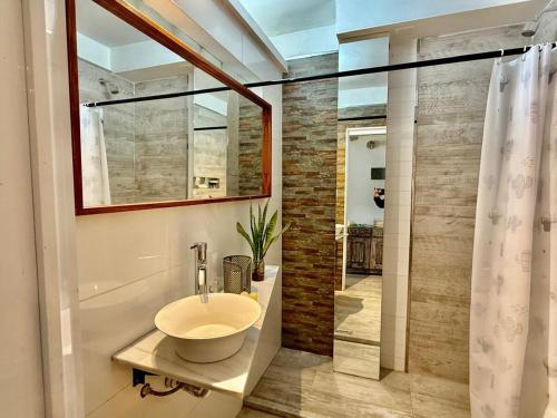a bathroom with a sink and a glass shower at Mini departamento LUMIC II in Santa Fe