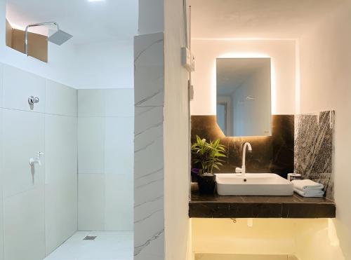 a bathroom with a sink and a mirror at Aqua Bliss Resort & Villa Bentota in Bentota