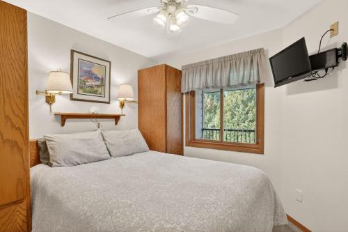 a bedroom with a bed and a window at Cedar Haven Unit 202 by Simple Life Rentals in Ephraim
