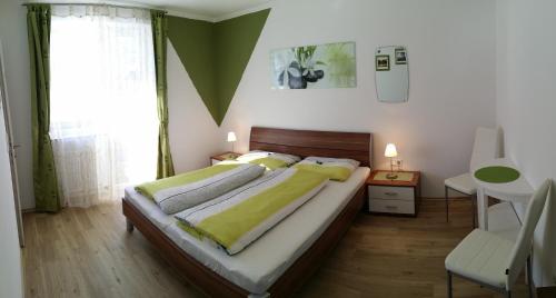 a bedroom with a bed and a desk and a window at Haus Reiter in Abtenau