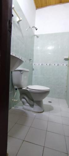 a bathroom with a toilet in a white room at Apartamento Brisa y Mar 2 in Arboletes