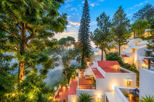 a view of a house in the forest at night at Sterling Yercaud in Yercaud