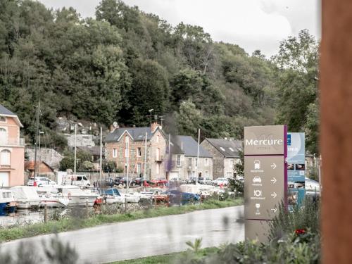 a sign for a marina in a small town at Mercure Dinan Port Le Jerzual in Dinan