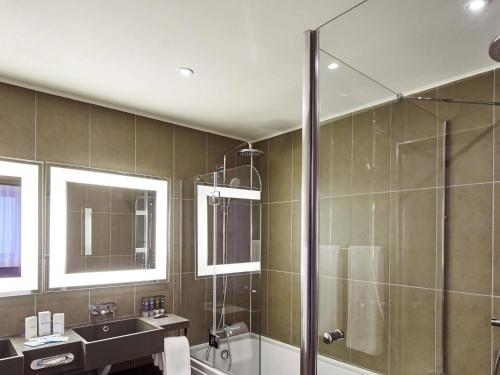 a bathroom with a shower and a sink at Novotel Konya in Konya