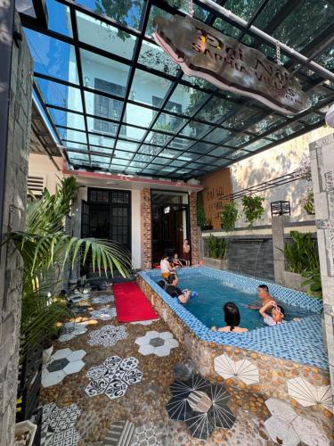 a group of people swimming in a swimming pool at Đại Nội Saphia Homestay & Villa in Hue