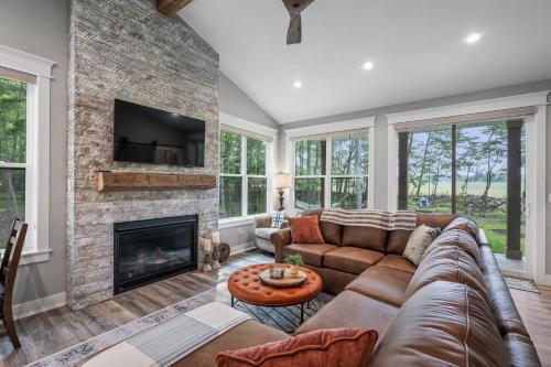 a living room with a couch and a fireplace at Stonehedge View by Simple Life Rentals in Egg Harbor