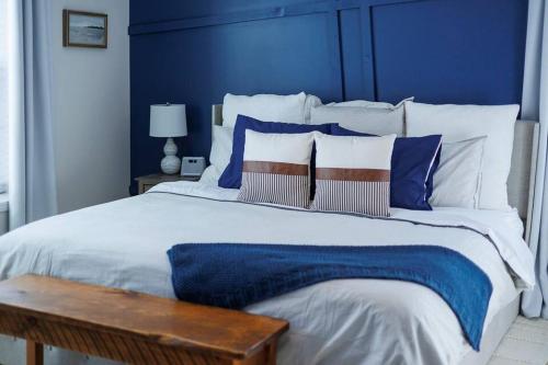 a blue bedroom with a large bed with a blue headboard at The Roost by Simple Life Rentals in Baileys Harbor
