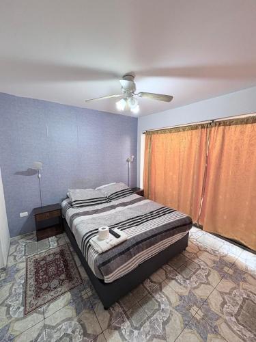 a bedroom with a bed and a ceiling fan at Hotel Simon II in Antofagasta