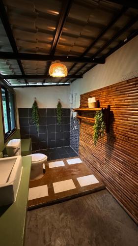 a bathroom with a tub and a toilet and a sink at Nong Thale Garden in Ban Khao Klom