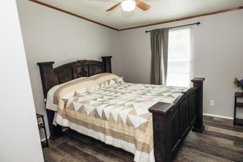a bedroom with a bed and a ceiling fan at The Hidden Creek Hideaway in Huntsville