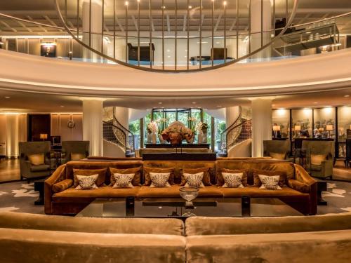 a living room with a couch and a table at Sofitel Frankfurt Opera in Frankfurt