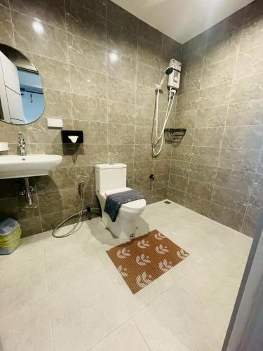 a bathroom with a toilet and a sink and a shower at The Camp in Kanchanaburi City