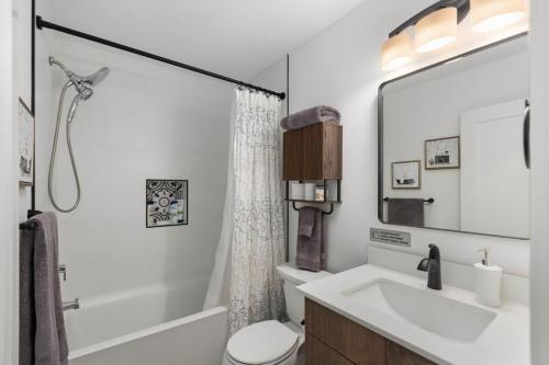 a white bathroom with a sink and a toilet at Modern House in Seattle in Seattle