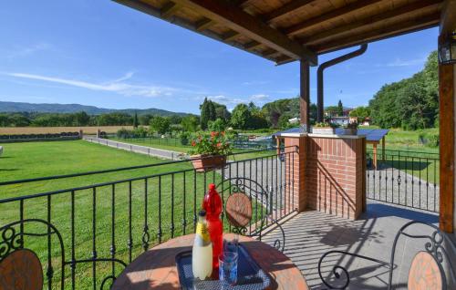 a porch with a table with a view of a field at Beautiful Home In Arezzo in Arezzo