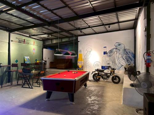 a room with a pool table in a garage at The Breeze Hostel in Haad Rin