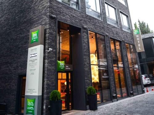 a store front of a brick building with windows at ibis Styles Tbilisi Center in Tbilisi City