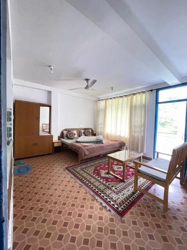 a living room with a couch and a table at Abhi house Naddi in McLeod Ganj