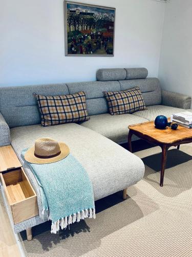 a living room with a couch with a hat on it at Classic Danish Holiday Home in Karrebæksminde