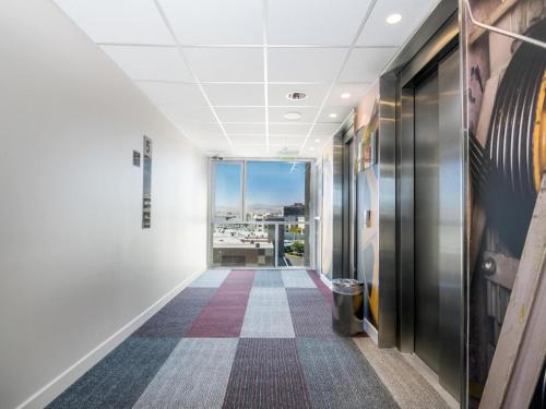 an office corridor with a view of a city at ibis Calama in Calama