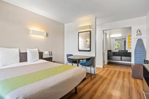 a hotel room with a bed and a table at Studio 6-Fairfield, CA - Napa Valley in Fairfield