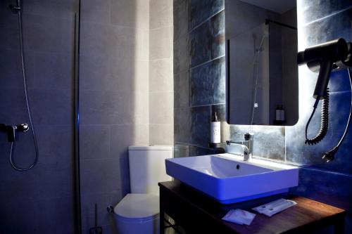a bathroom with a sink and a toilet and a shower at Borjomind Hotel Borjomi in Borjomi
