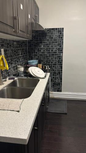 a kitchen with a sink and a counter top at Casa Toronto in Toronto