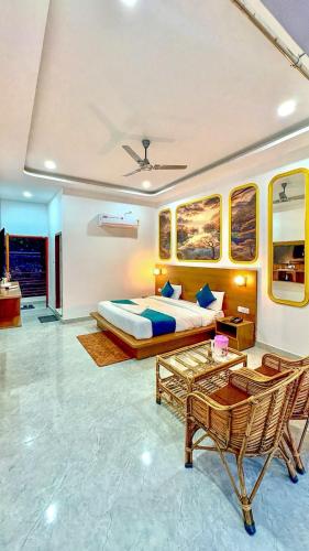 a bedroom with a bed and a table and a chair at Boho Stays Rishikesh in Rishīkesh