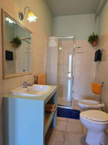 a bathroom with a sink and a toilet and a shower at Villa Patrizia in Taviano