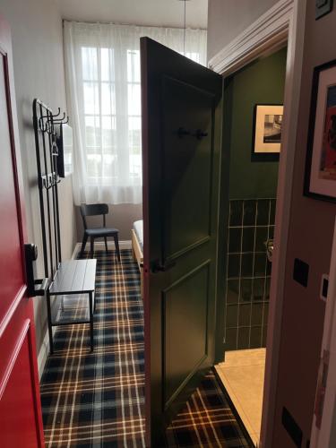 a hallway with a green door in a room at The Brewhouse Hotel in Edinburgh