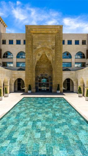 a large building with a swimming pool in front of it at Kempinski Hotel The Dome Belek in Belek