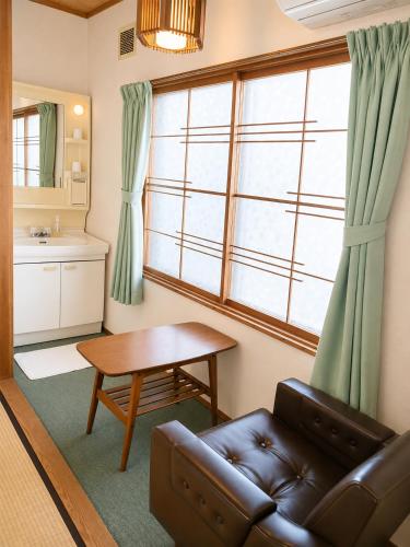 a living room with a couch and a table at Hotel Sol at Lake Toya in Lake Toya